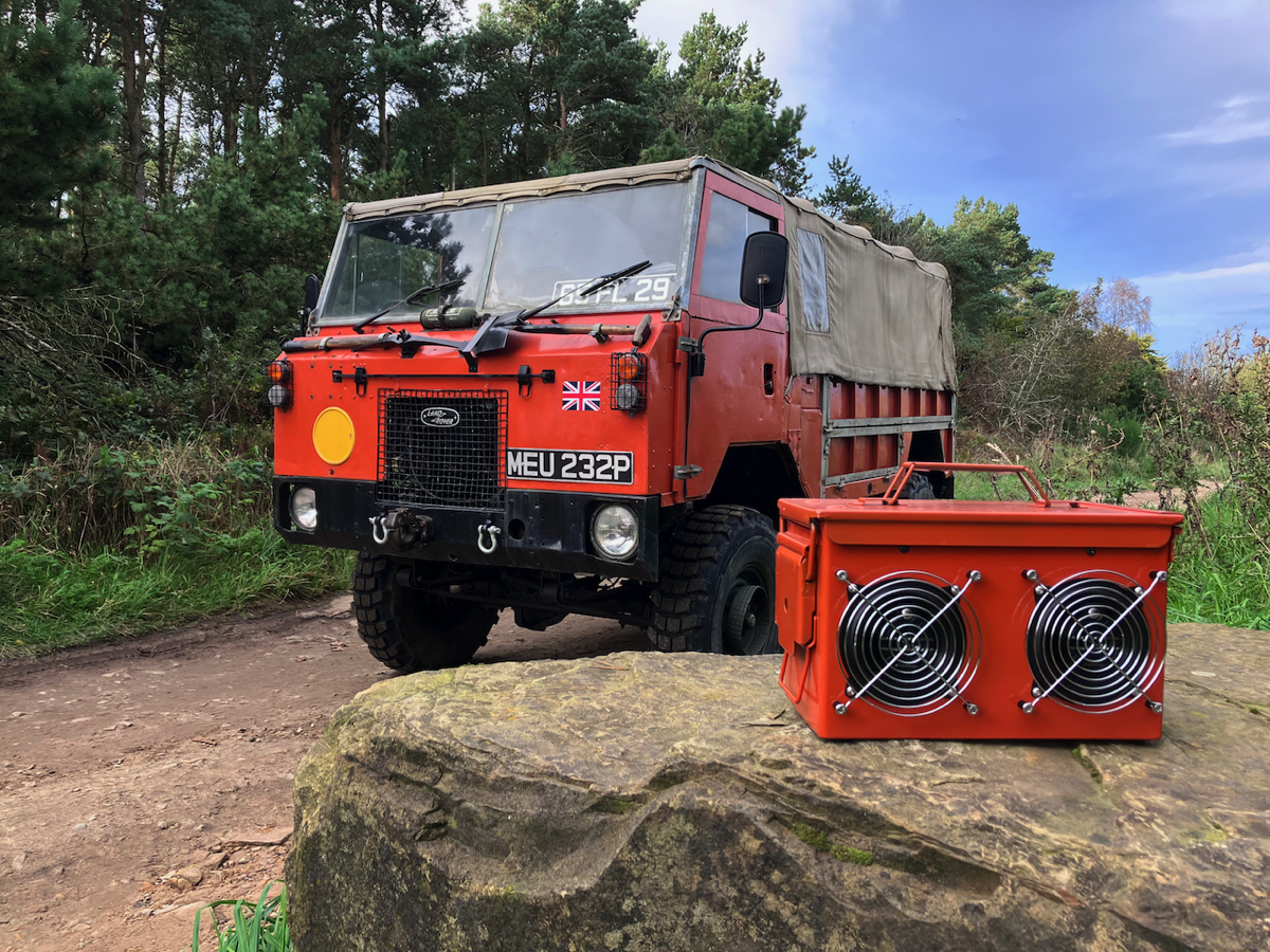 A bright orange ammo box speaker panted to match a Land Rover 101 Forward Control